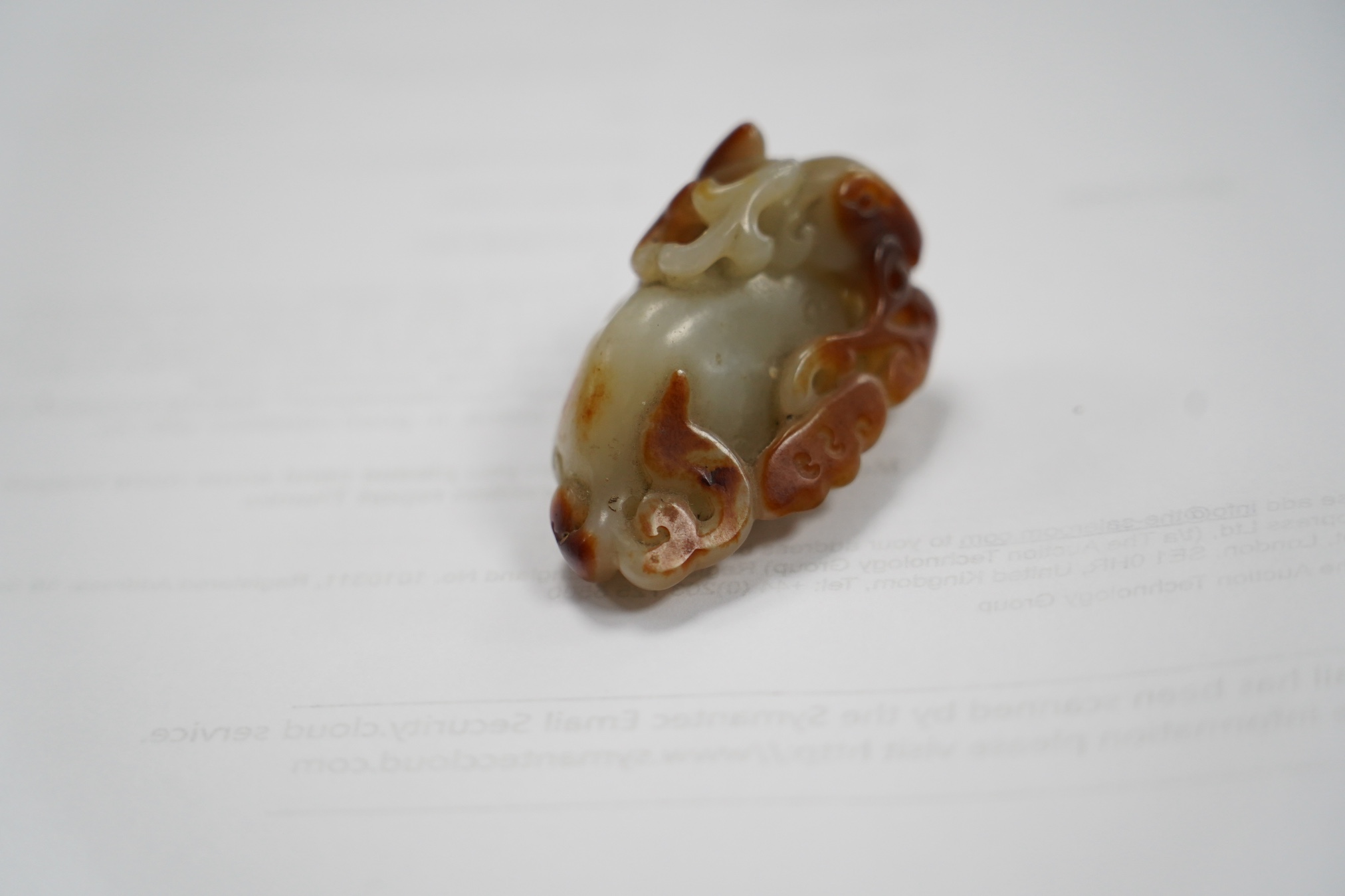 A Chinese pale celadon and russet skin jade figure of a stag, 19th century